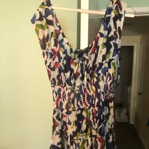 Multi colored sundress with white base.